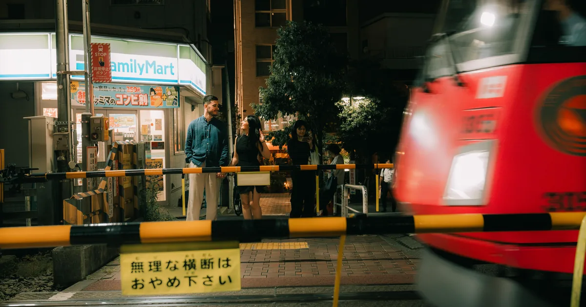 The Setagaya Line tram passing a level crossing in Sangenjaya, a backstreet location for a Tokyo photoshoot